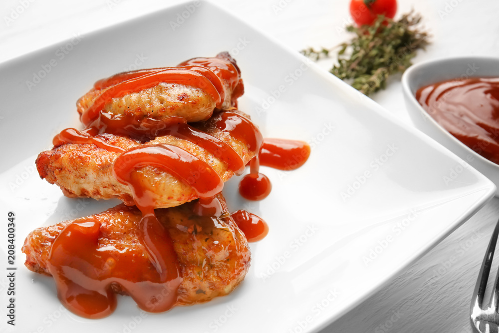 Roasted chicken with barbecue sauce on plate, closeup