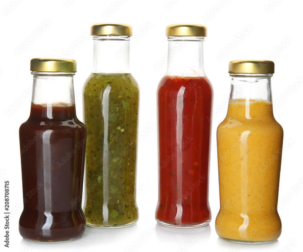 Bottles with tasty sauces on white background