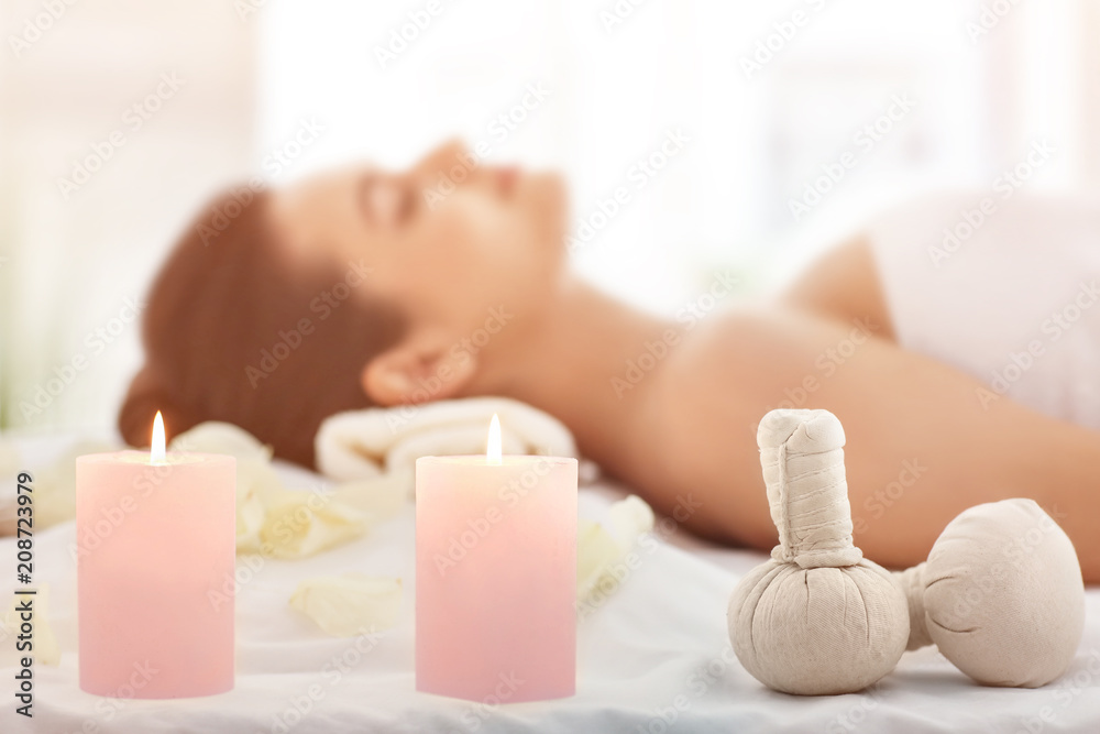 Spa accessories and relaxed young woman on background