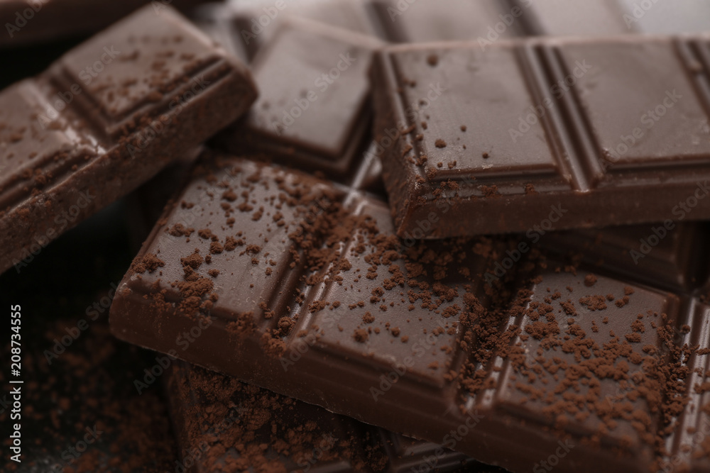 Tasty milk chocolate and cocoa powder, closeup