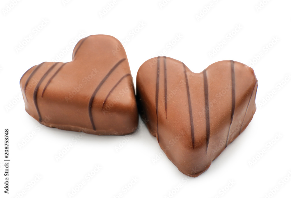 Tasty heart-shaped chocolate candies on white background