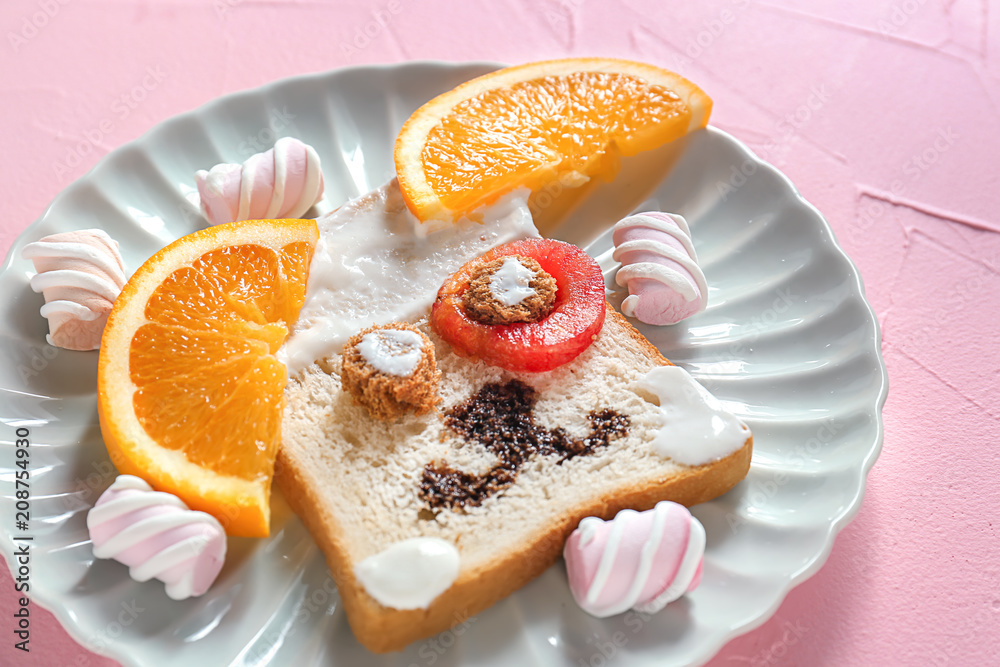 Plate with creative toast for children on color background