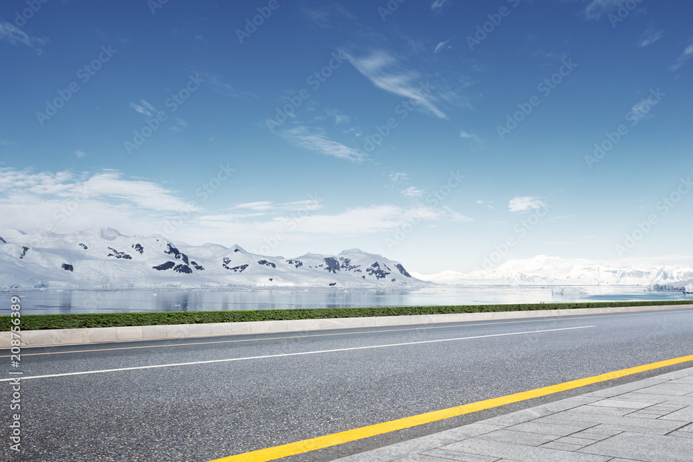 empty asphalt road with snow mountain