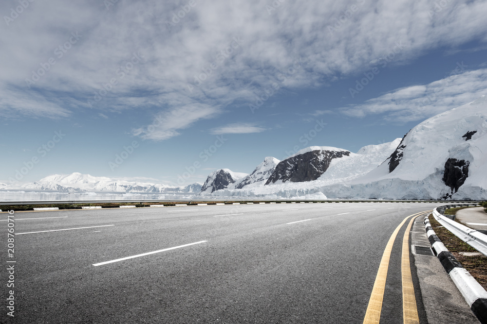 empty asphalt road with snow mountain