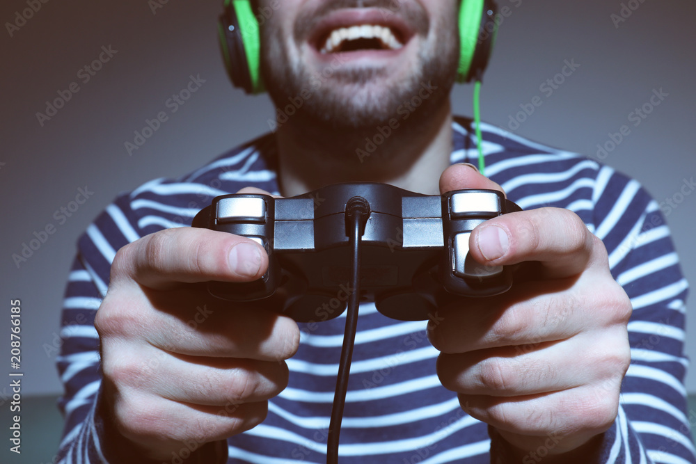 Young man playing video games at home