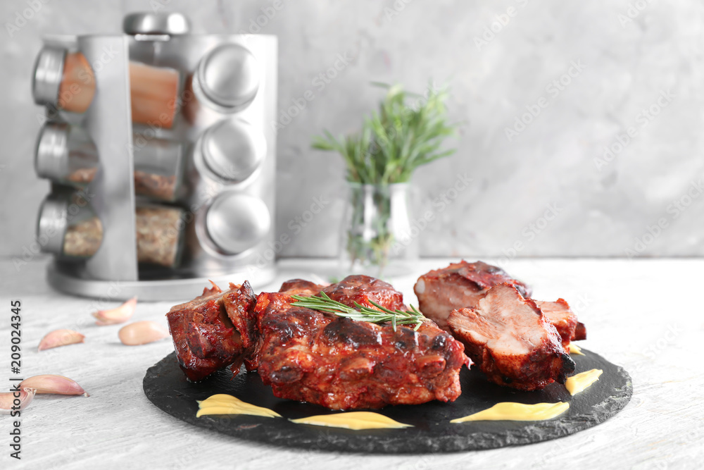 Delicious grilled ribs with sauce on slate plate