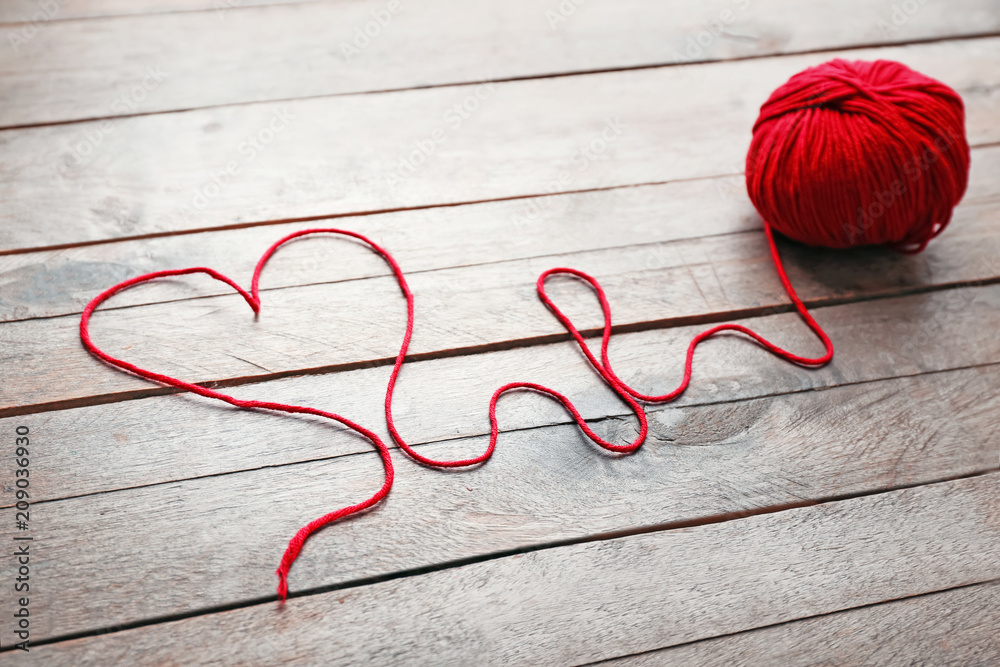 Ball of knitting yarn on wooden table