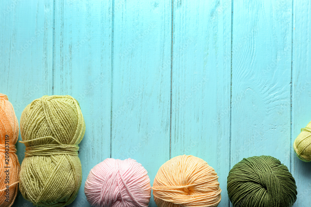 Colorful knitting yarn on wooden table