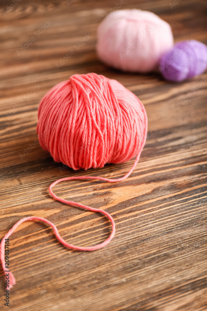 Ball of knitting yarn on wooden table