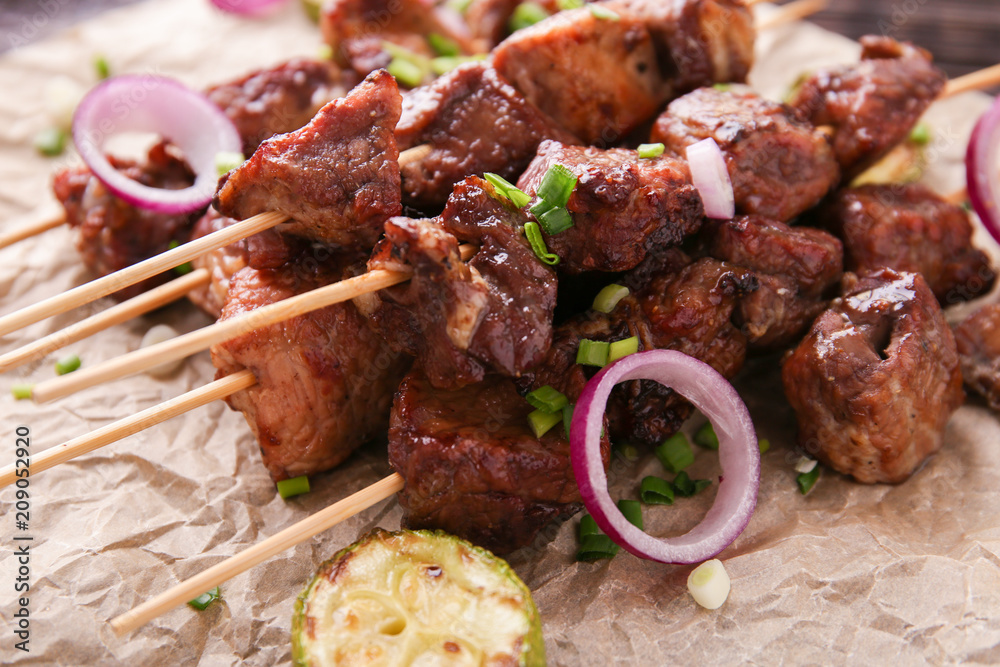 Barbecue skewers with juicy meat on parchment