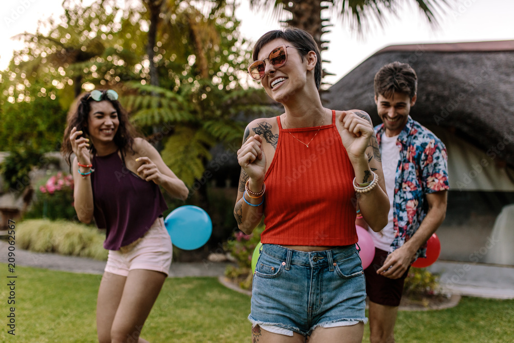 People playing balloon popping game at party