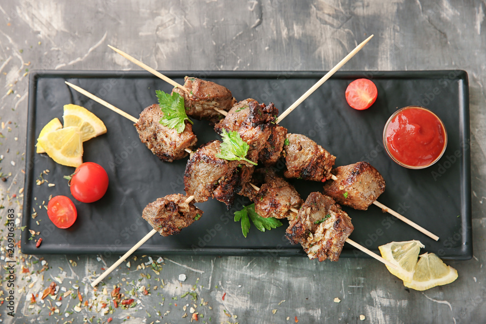 Barbecue skewers with juicy meat and sauce on plate