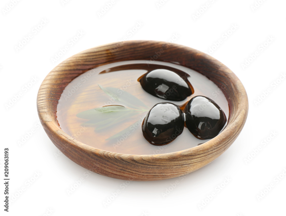 Bowl with oil and canned olives on white background