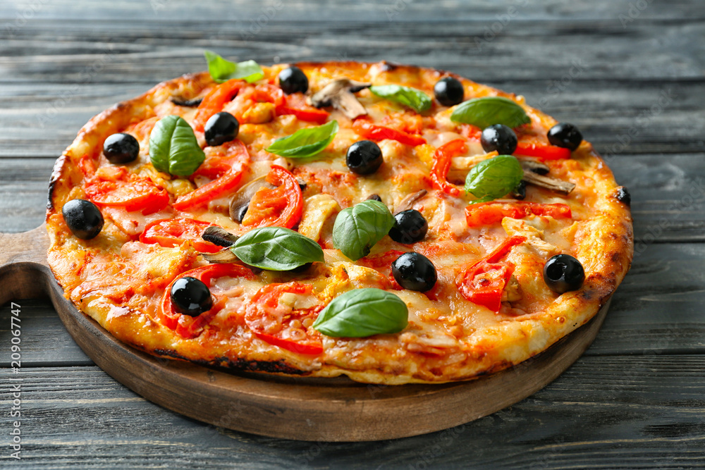 Board with tasty Italian pizza on wooden table