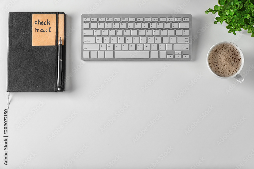 Sticker with phrase CHECK MAIL, computer keyboard and cup of coffee on white background