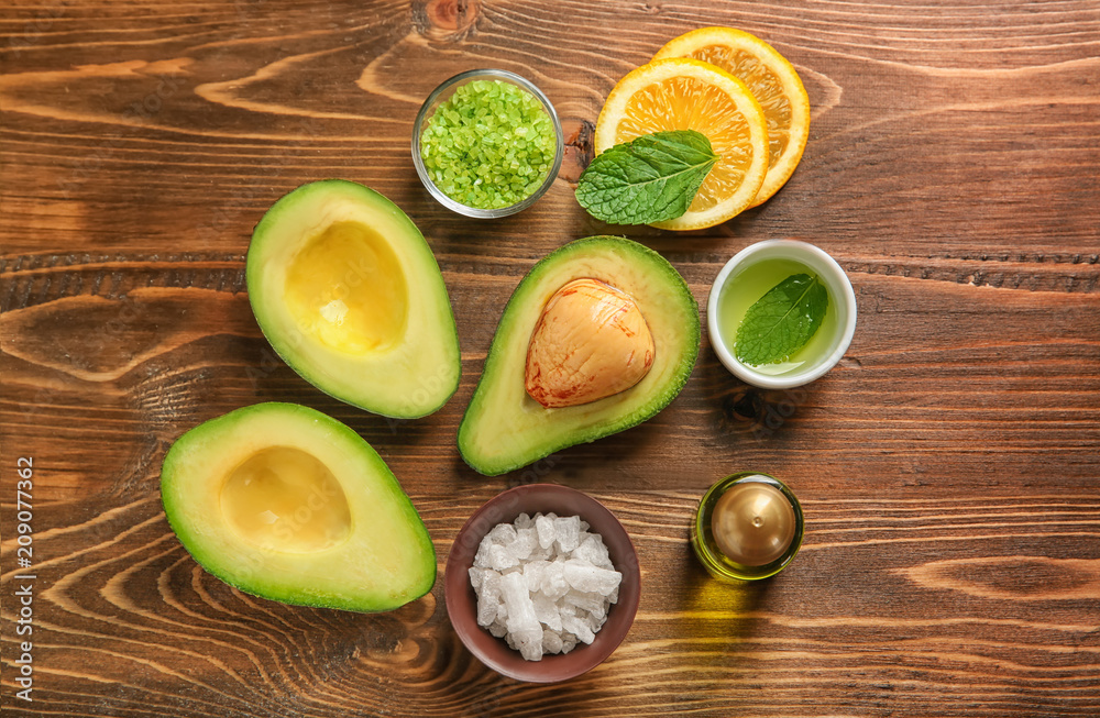 Avocado with ingredients for natural homemade cosmetics on wooden background