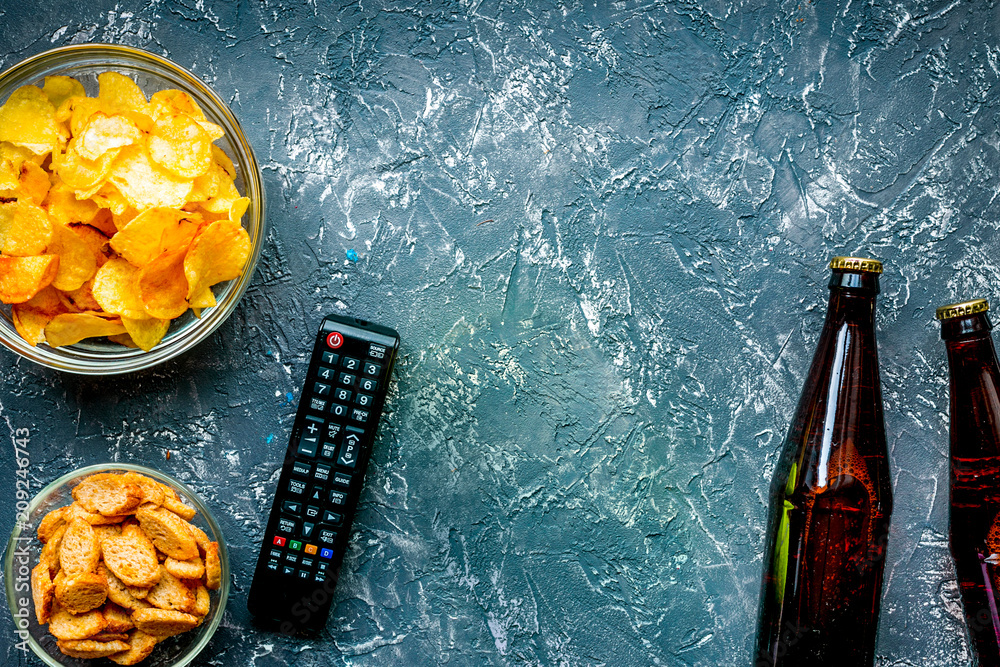 snacks for watching sport match on dark background top view mock