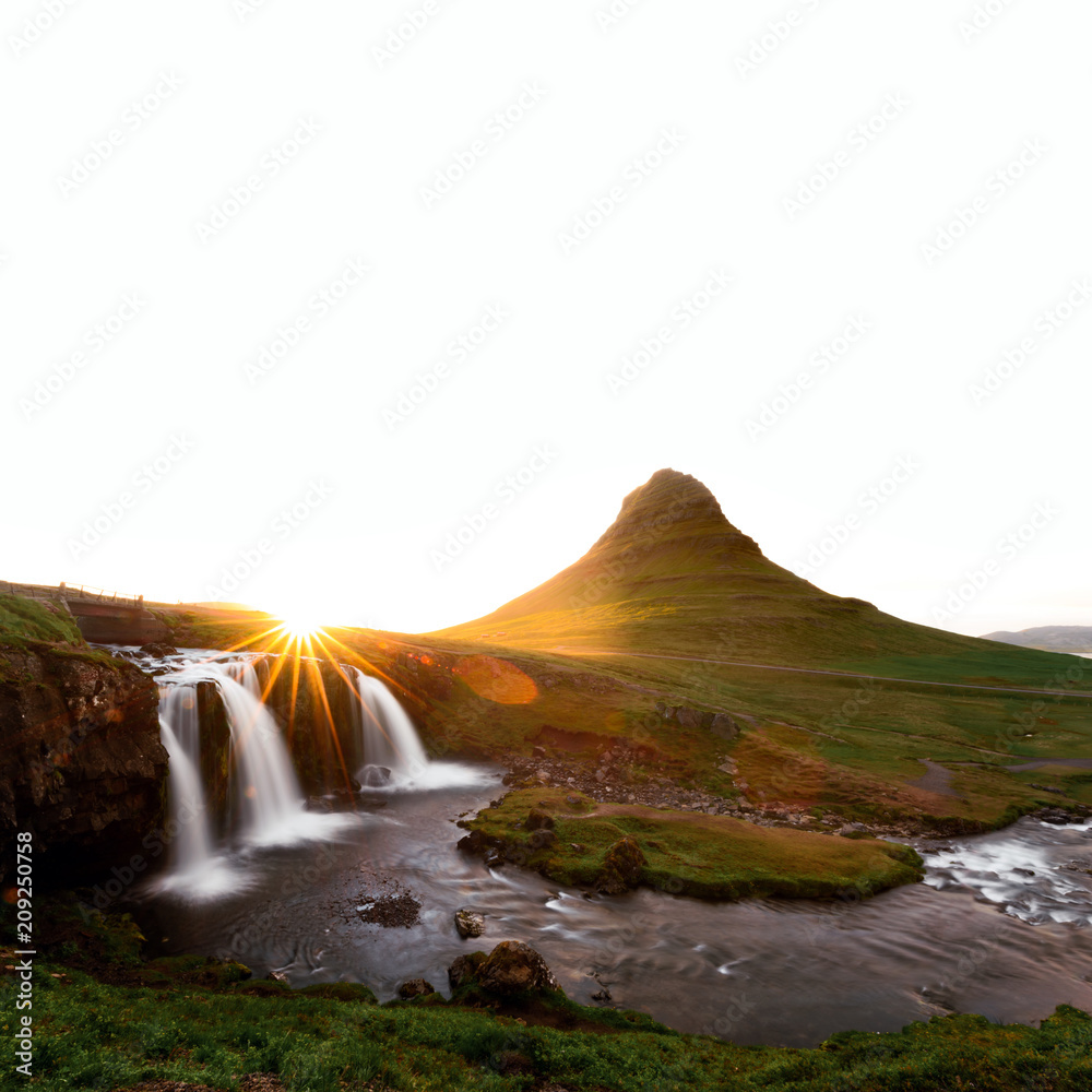 Colorful sunrise on Kirkjufellsfoss waterfall. Amazing morning scene near Kirkjufell volkano, Icelan