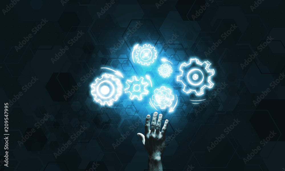 Glowing cogwheel mechanism icon on dark background as symbol of teamwork