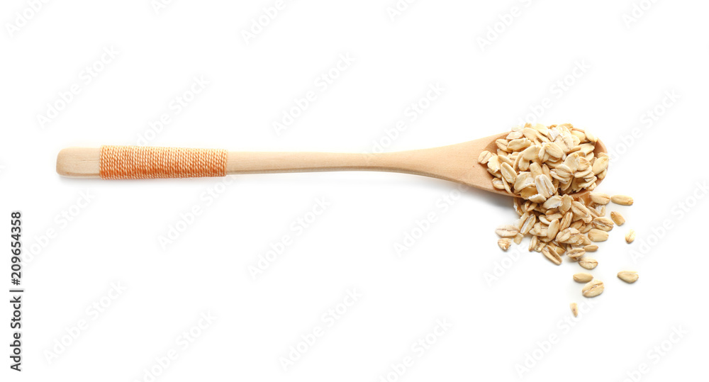 Spoon with raw oatmeal on white background