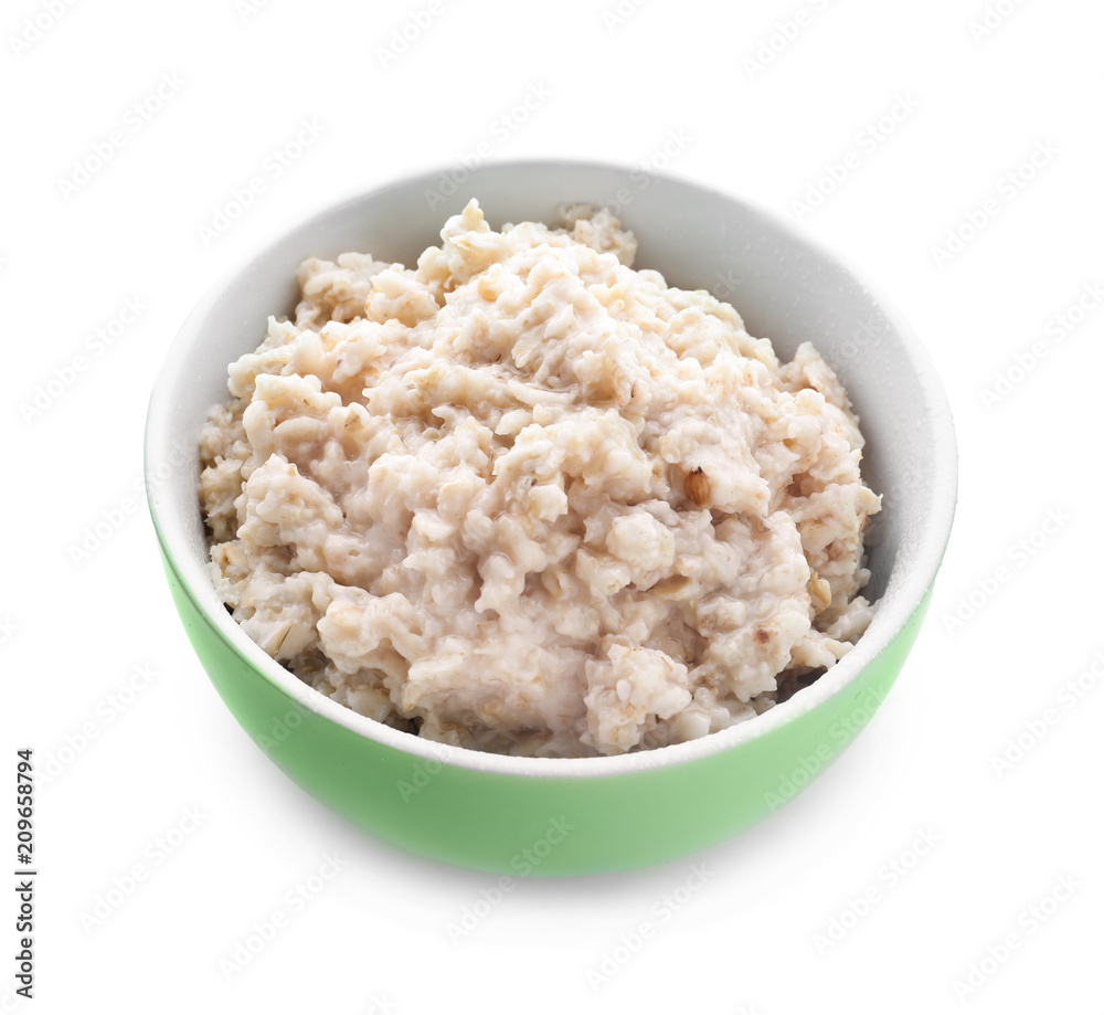 Tasty oatmeal in bowl on white background