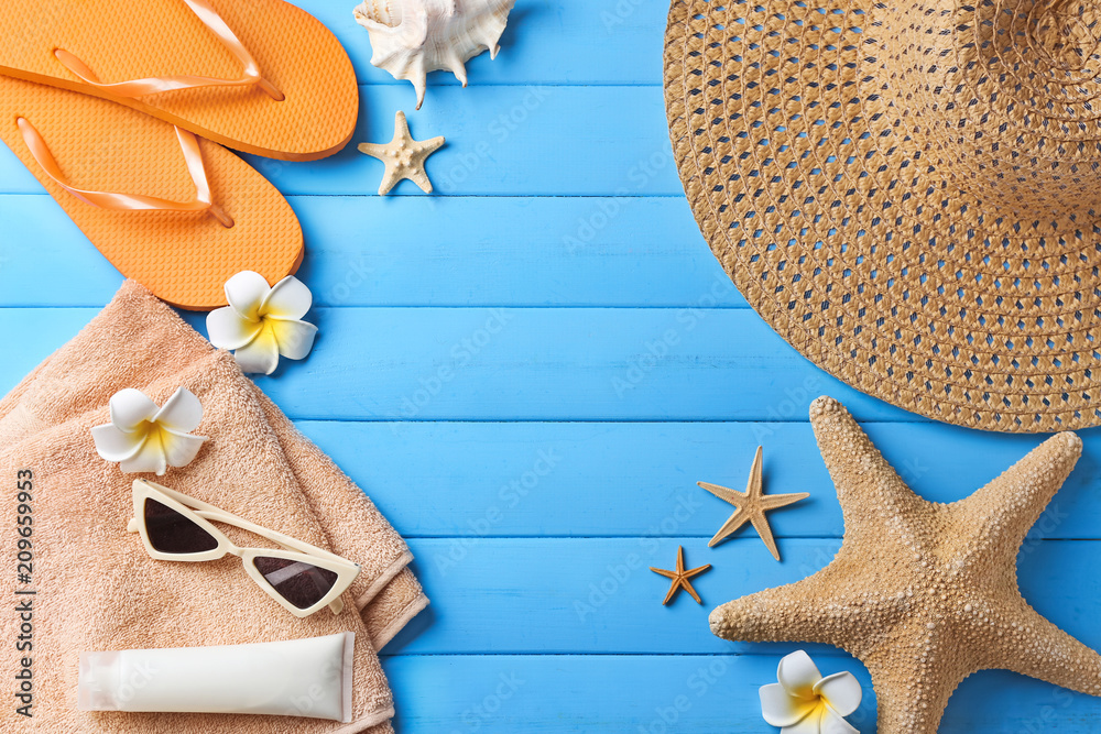 Composition with beach accessories on color wooden background