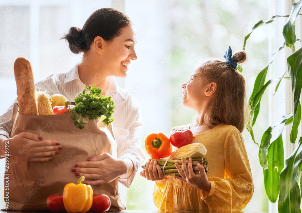 Mother and daughter holding shopping bag