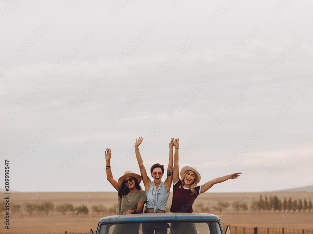 Friends having fun in the open back of a truck