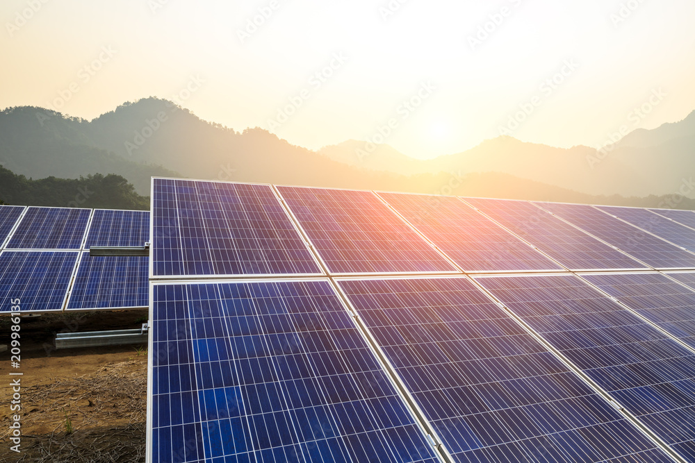 Solar panels and mountains landscape at sunrise