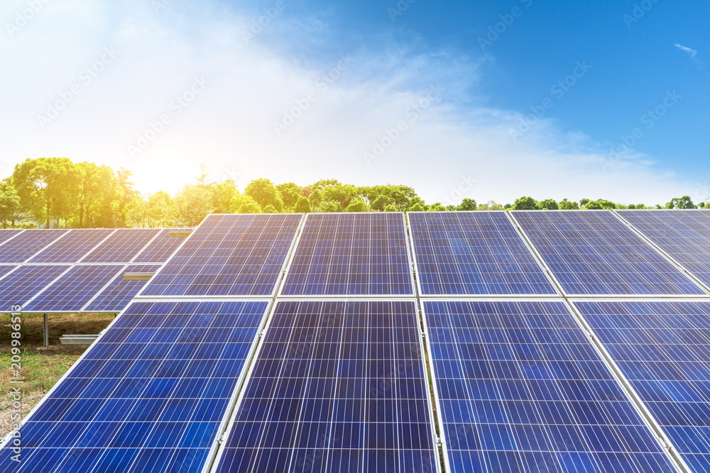 Solar panels and blue sky with white clouds