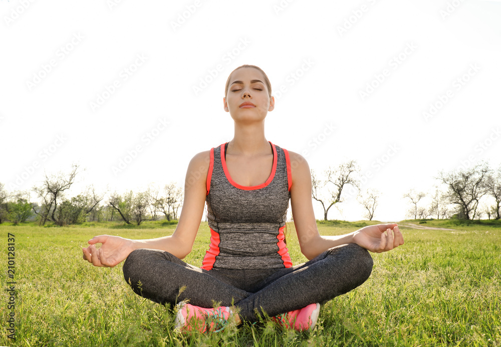 Young woman practicing yoga outdoors