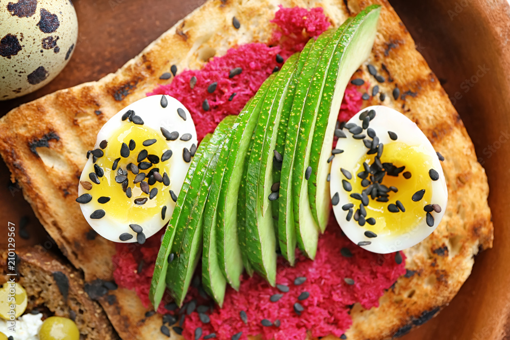 Tasty toast with avocado on plate, closeup