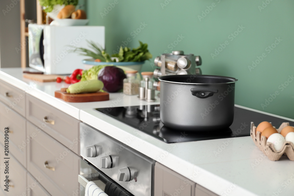 Electric stove with stewpan in kitchen