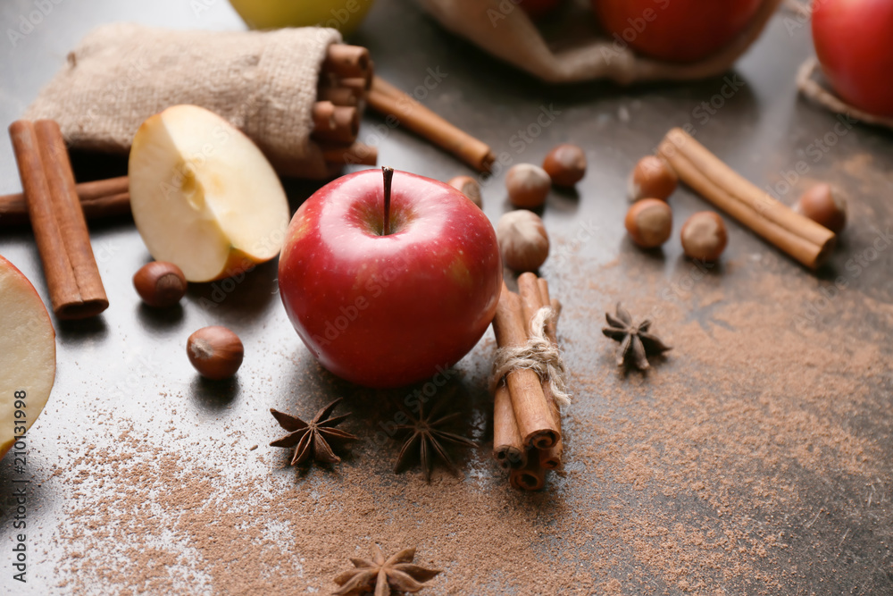 Fresh ripe apples and cinnamon on table