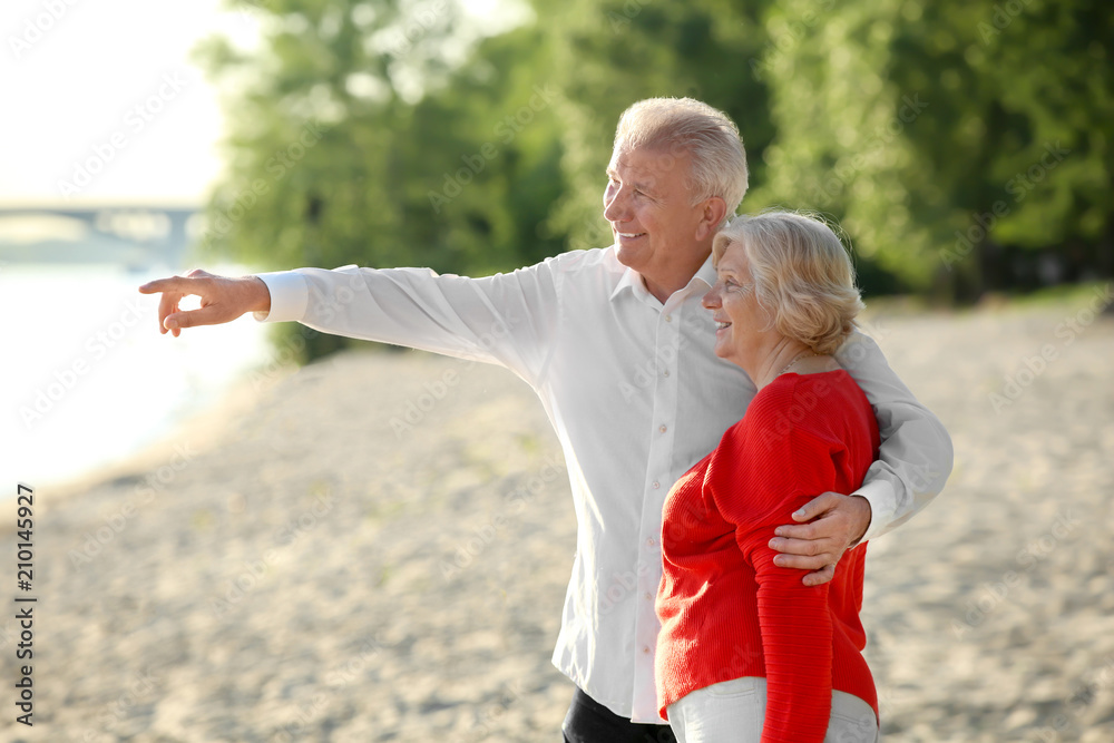 Happy mature couple on riverside