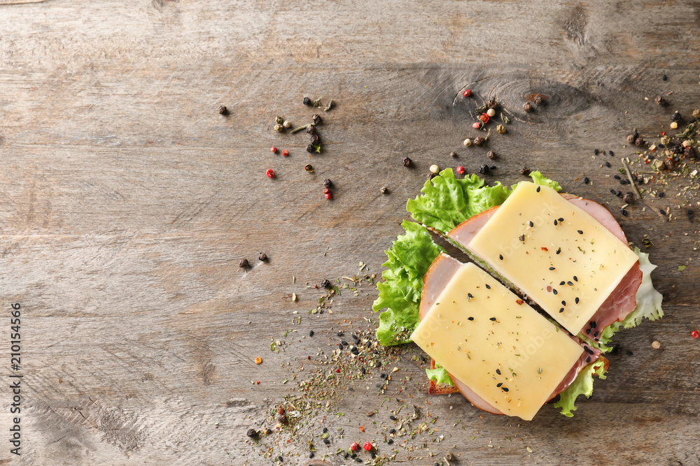 Toasted bread with ham and cheese on wooden table