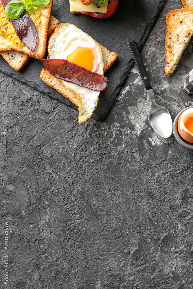 Composition with toasted bread and eggs on textured table