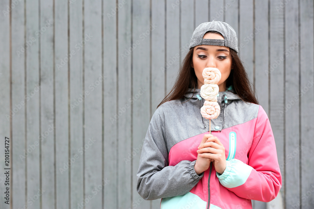 Attractive young woman with lollipop outdoors