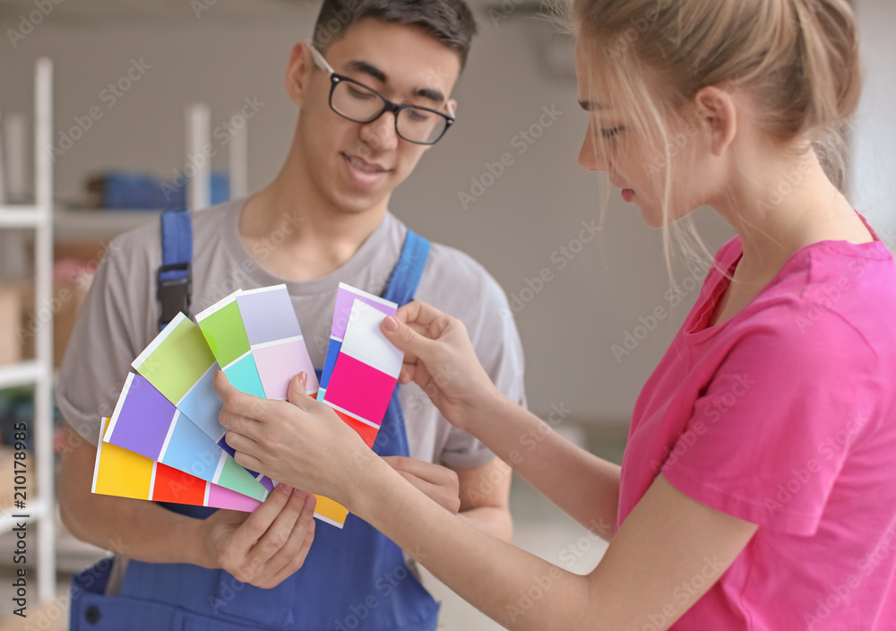 Professional painters choosing the color of wall indoors