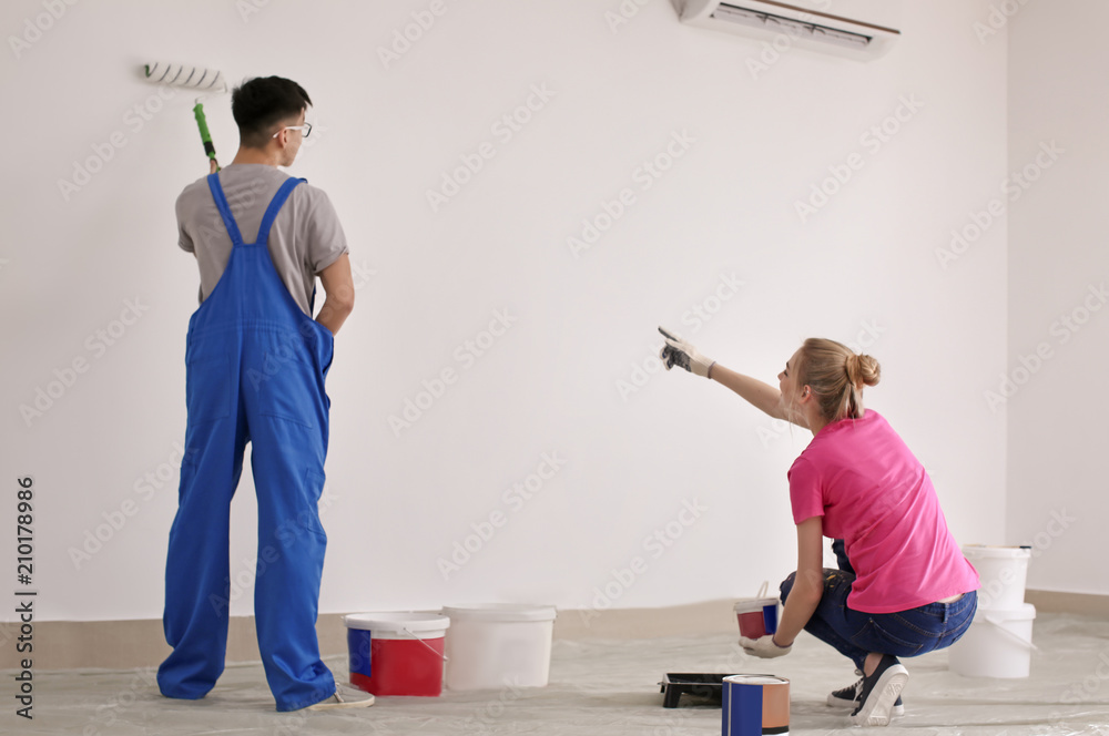 Professional painters working together indoors