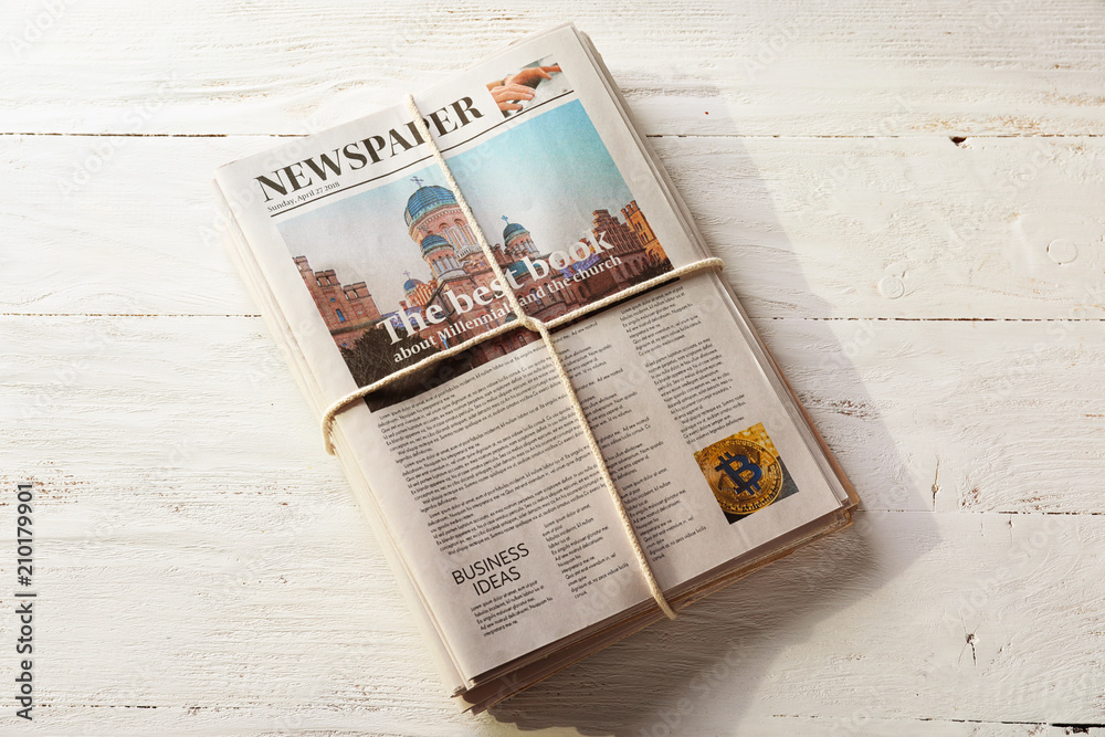 Pile of newspapers on white wooden background