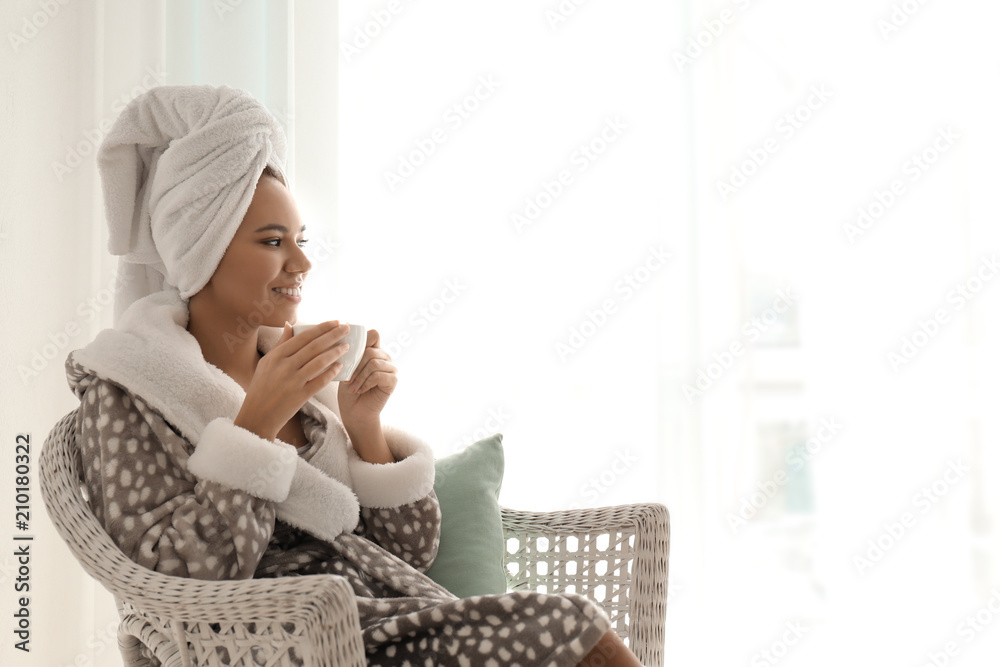 Morning of beautiful African-American woman drinking coffee at home