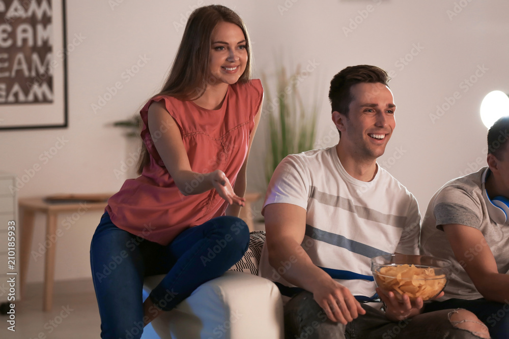 Young people having fun at home in evening