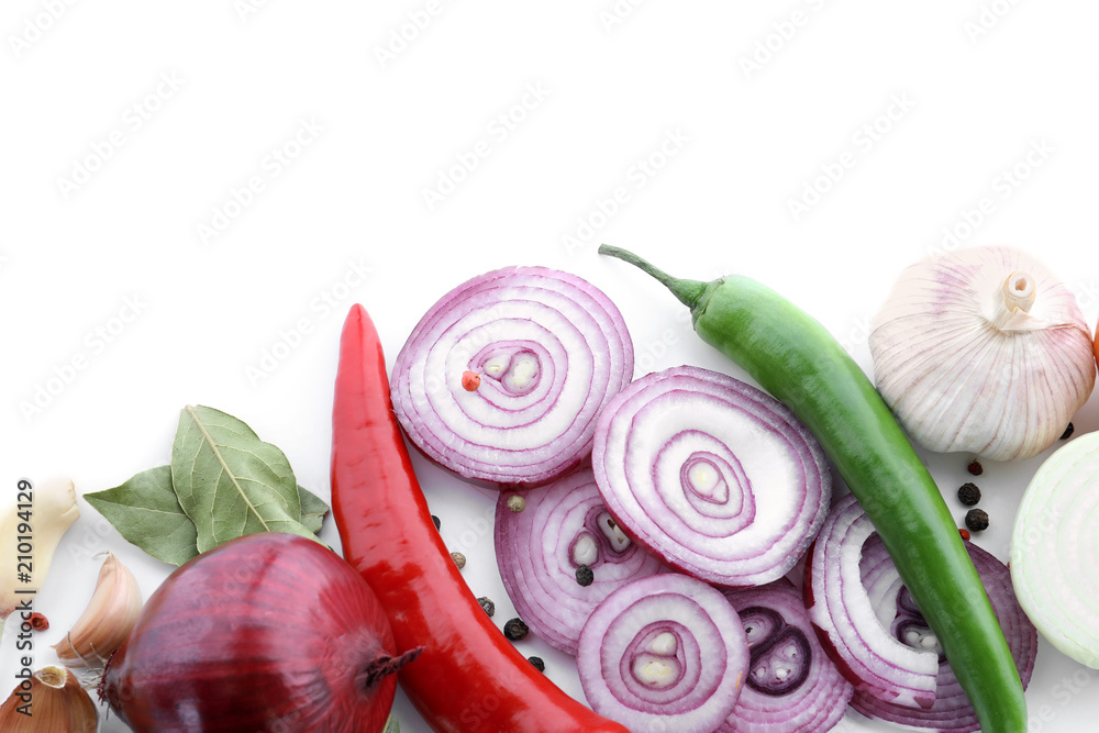 Composition with red onion, garlic and fresh spices on white background