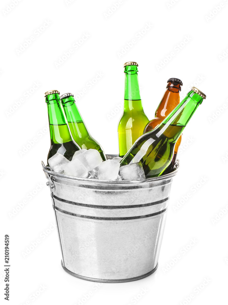 Bottles of beer in ice bucket on white background