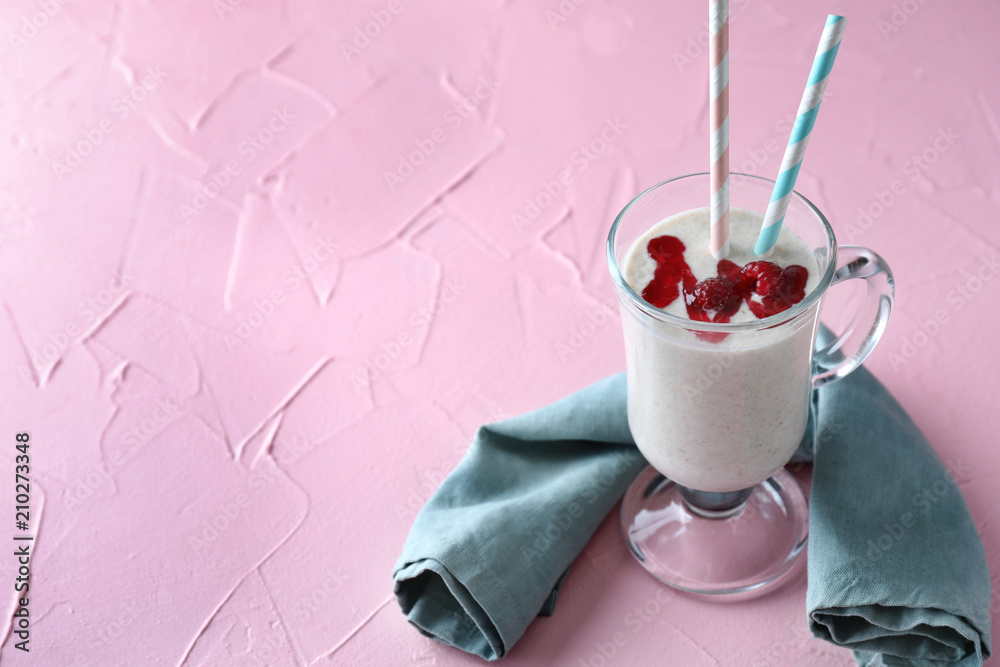 Tasty oatmeal smoothie with fresh raspberries in glass cup on color textured background