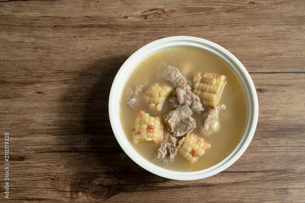 Bone soup with wood grain background