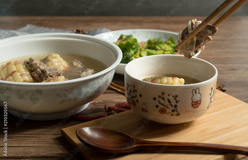 Bone soup with wood grain background