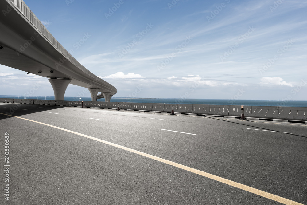 asphalt road with city skyline