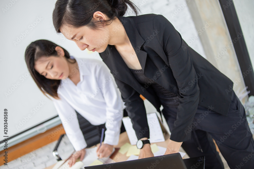 asian businesswoman  working with partner with happiness in office